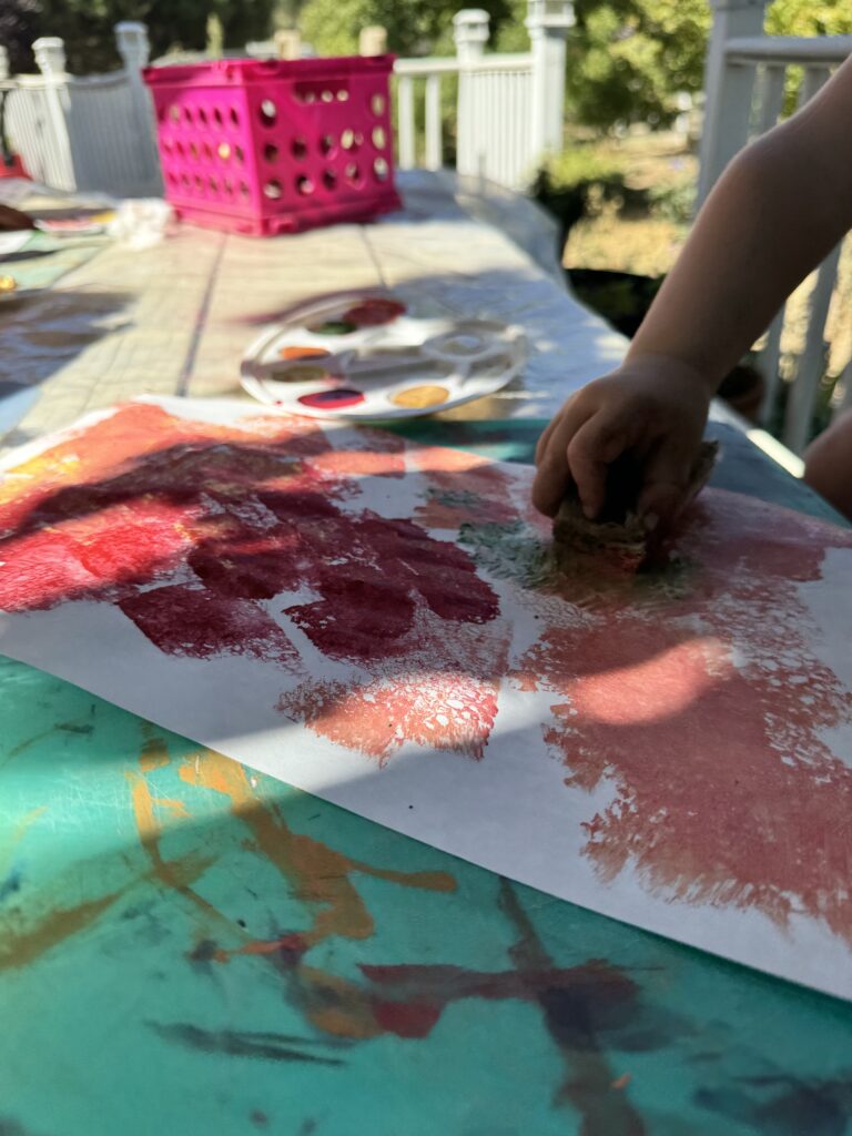 child sponge painting with fall colors